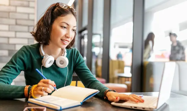 Young Happy Business Asian Woman Taking Notes In Notebook And Working With Laptop Pc Or Computer. Education And Working Concept. Modern Freelance Professions 1024X683